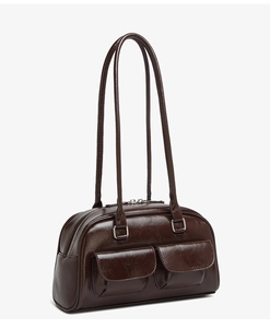 Detailed side view of dark brown oil-wax leather shoulder bag with double front pockets