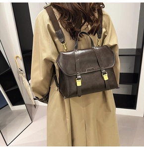 Retro dark brown leather backpack with contrast stitching and metallic buckles