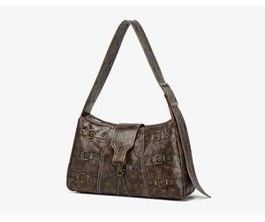 Detail of vintage brown leather tote bag featuring multiple retro brass buckles and straps