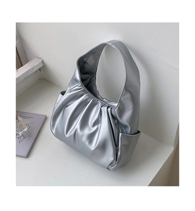 Detailed view of silver matte pleated hobo bag with unique cloud texture and integrated strap