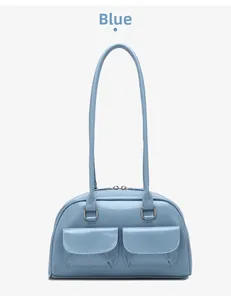 Detail view of light blue vintage faux leather shoulder bag with two front flap pockets