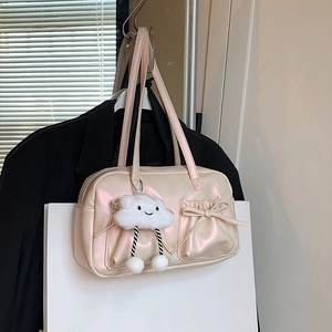 Pink pearlescent Boston tote bag with bow drawstring pockets and a plush cloud charm