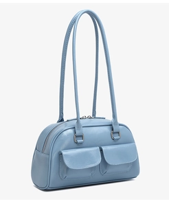 Detail of light blue oil wax leather handbag with silver zippers and double front pockets