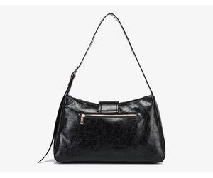 Detail of vintage black tote bag showing back metal zipper pocket and cracked leather texture