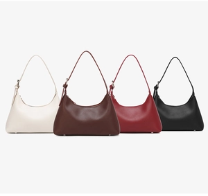 Flat lay of minimalist hobo bags in four colors with adjustable shoulder straps