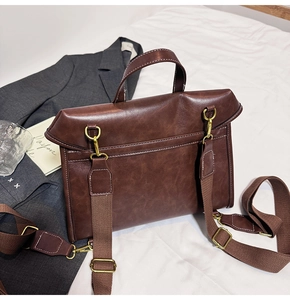 Deep brown PU leather backpack detail with gold metal buckle on a white bedding background