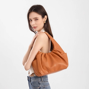 Brown ruched dumpling shoulder bag with minimalist leather design and wide strap