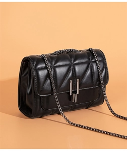 Detailed view of black quilted pattern with vintage metal chain and vertical bar lock