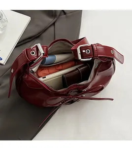 Top view of spacious burgundy hobo bag interior with umbrella, wallet, and essentials