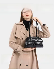 Detailed view of luxury black oil-wax leather bowling bag with functional pockets