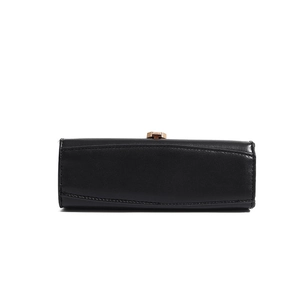 Close-up of black leather handbag base with neat stitching and gold metal clasp detail