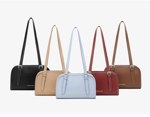 Minimalist shoulder bags in five colors showing adjustable straps and gold logo details