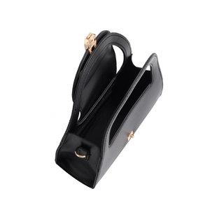 Close-up of black leather semicircular bag showing golden lock and interior space