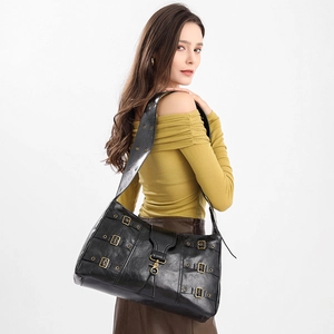 Retro punk style large black tote bag with wide strap and vintage metal hardware