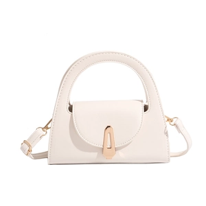 Detail of cream semi-circular handbag with gold geometric buckle and smooth leather
