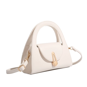 Detail of white semi-circle handle handbag with golden geometric clasp and adjustable strap