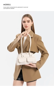Detail of cream oil wax leather bowling bag with double front pockets and shoulder straps