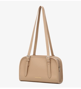 Close-up of khaki leather underarm bag featuring white stitching and gold lettering