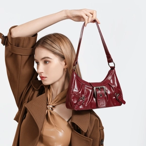 Retro deep red glossy leather shoulder bag with metallic buckle and Y2K aesthetic