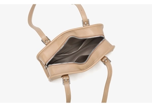 Top view of beige leather handbag showing interior gray fabric lining and dual pockets