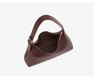 Detailed top view of dark brown leather bag showing wide zipper opening and metal buckle