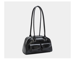 Detail of oil wax leather shoulder bag with twin front pockets and silver hardware