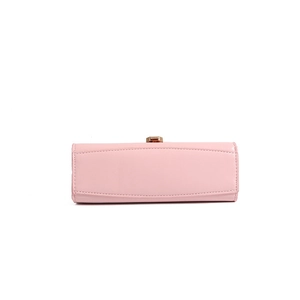 Detail of light pink patent leather handbag with elegant gold metal clasp and stitching