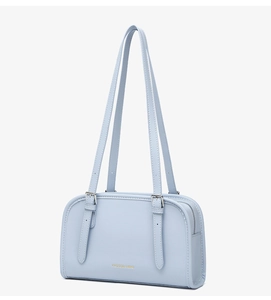 Detail of light blue minimalist shoulder bag featuring gold Fashion & Bag lettering
