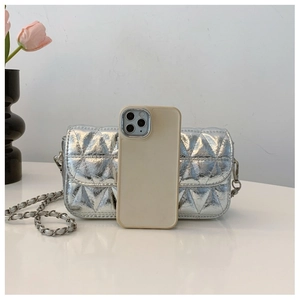 Silver quilted chain bag with high-gloss finish next to tulips and a smartphone