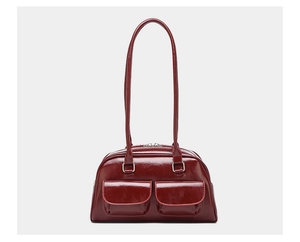 Front detail of deep red glossy oil wax leather shoulder bag with double pockets