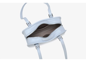 Top view of light blue glossy handbag showing interior lining and silver zipper detail