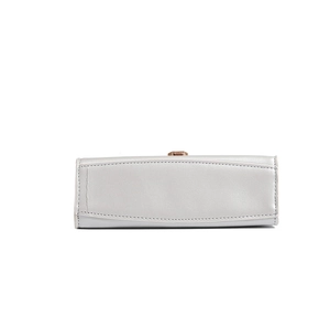 Close-up of high-quality stitching and golden metal lock on the semi-circular bag