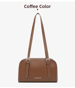 Close-up of coffee brown leather shoulder bag with white contrast stitching and buckle