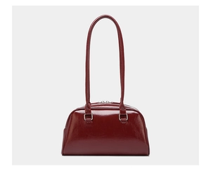 Front view of a dark red oil wax leather bowling bag with glossy finish and silver hardware