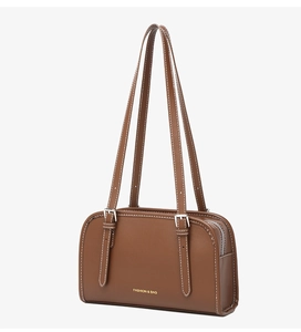 Detailed side view of brown leather bag with contrast stitching and silver hardware