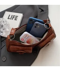 Spacious interior of retro brown crescent baguette bag showing capacity for daily essentials