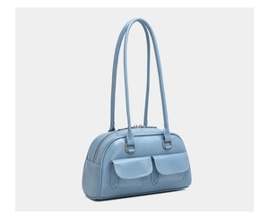Detail view of light blue oil wax leather bowling bag featuring front flap pockets
