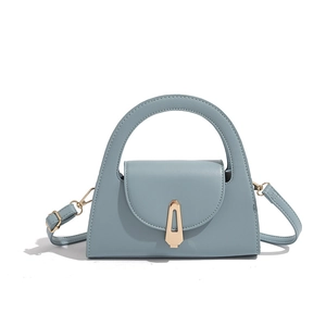 Close-up of light blue semi-circular handbag with gold shield lock and smooth PU leather
