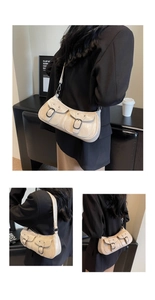 Detail of vintage beige crescent bag featuring dual utility pockets and metallic hardware