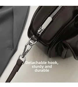 Detail of dark burgundy wax leather bag with durable silver metal zipper and detachable hook