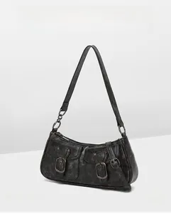 Detail of vintage gray faux leather bag with two front pockets and aged metallic buckles