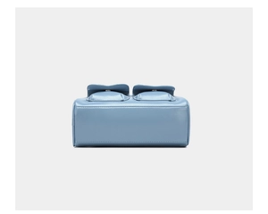 Detail view of light blue oil wax leather handbag with two front pockets and silver buckles