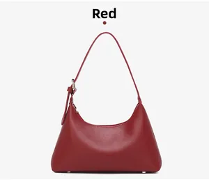 Close-up of red leather underarm bag with silver hardware and smooth texture finish