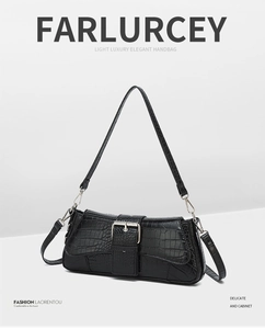 Detail of black crocodile texture baguette bag with silver metallic buckle and strap