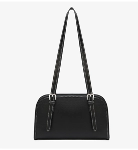 Detail of black shoulder bag showing white contrast stitching and silver metal buckles