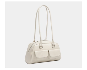 Detail view of cream white oil wax leather shoulder bag featuring dual front pockets and zip