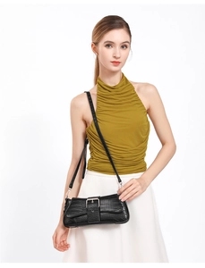 Modern black crocodile pattern baguette bag worn over the shoulder with silver buckle