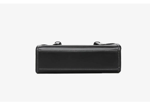 Close-up of black handbag bottom featuring high-quality white contrast stitching details