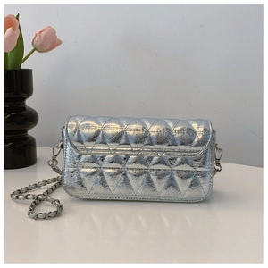 Detail of silver quilted crossbody bag with glossy metallic texture and chain strap
