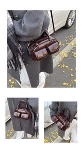 Detail of dark brown glossy leather handbag featuring dual front pockets and metal zippers